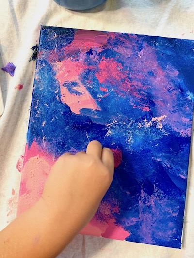 Go back over painting with cotton ball to keep creating the cloudy texture effect. The paint will mix in places which helps create the outer space look!