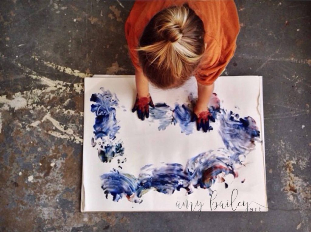 nurture your child's creativity, a small child finger paints