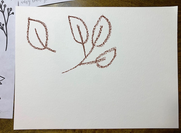 drawing a leaf on watercolor paper with oil pastel