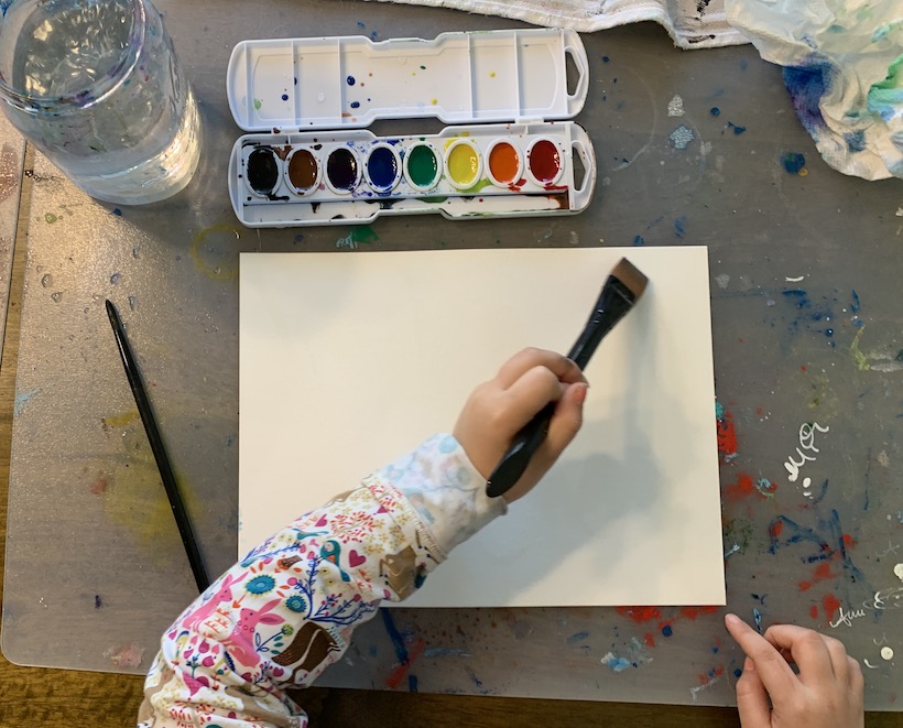 Nurture your child's creativity, a child paints with watercolor