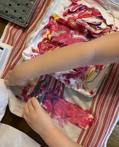 nurture your child's creativity, a child creates a shaving cream print